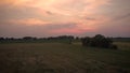 Drone flight over a field with a sunset