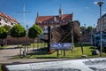 Wreck of a wooden ship and historical townhall building in Kamien Pomorski, Poland.