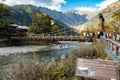 Kamikochi, Nagano, Japan - October 2022 : Unidentified tourists enjoyment at Kappa bashi Bridge at center point area of Kamikochi