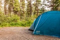 KAMLOOPS, CANADA - JULY 07, 2020: blue Coleman camping tent in forest camp site lifestyle advanture