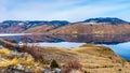 Kamloops Lake with the surrounding mountains reflecting on the quiet surface