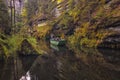 The Kamnitz Gorge, Czech Republic - a boat with a ferryman and tourists on river flowing through rocky ravine