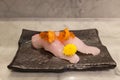 Kampachi sushi with Uni and Ikura on top on black ceramic plate Royalty Free Stock Photo