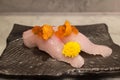 Kampachi sushi with Uni and Ikura on top on black ceramic plate Royalty Free Stock Photo