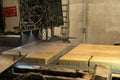 Kampen - The Netherlands - May 11 2017 - Production line where concrete paving tiles are impregnaned with waterresistant substance