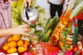 Kamphaeng Phet Thailand-14 Jan 2022: Hand person holding teapot, pouring tea full of glass. Royalty Free Stock Photo