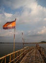 Cambodian flag on old traditional bamboo wooden bridge across Mekong river