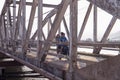 Kampot, Cambodia - 12 April 2018: khmer family drives motorbike on old bridge. Asian family with kid on motorbike Royalty Free Stock Photo