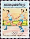 KAMPUCHEA - CIRCA 1984: A stamp printed in Kampuchea shows relay race, circa 1984. Royalty Free Stock Photo