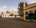 A wide deserted avenue with an old palace and vintage architecture in the village