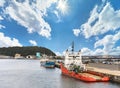 Offshore standby vessel and sand carrier ship moored at Yokosuka New Port Pier in the Kurihama port. Royalty Free Stock Photo