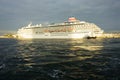 Sun rays break through storm clouds in the evening sky. Cruise ship Asuka II at sunset