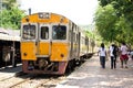 Yellow Diesel train on track at a platform.