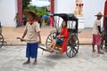 Kanchanaburi, Thailand, 09.09.2019: Beautiful Thai girl in traditional Thai, Siamese dress in an old rickshaw in front of the