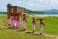 Group of Mon nuns walking out of ruined Buddhist church