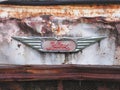 Logo of the Hino Motor`s Ltd. brand on a the front of the rusty truck background