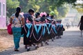 Kanchanaburi Thailand, Mar 6, 2020: Asian kids boys and girls graduate walking in a line with parents. Children wore black robes,