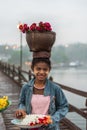 Mon woman carry basket on the head on Mon Bridge