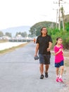 KANCHANABURI/THAILAND-MAY 7,2020 : Unidentified Thai sportive people jogging for good health on road beside irrigation canal at