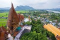 Kanchanaburi, Thailand-October 23, 2022 : Aerial view of Asian tourists at Wat Tham Seua, beautiful and ancient big golden Buddha