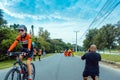 KANCHANABURI, THAILAND-OCTOBER 6,2019 : Back view of unidentified sport photographer sit to take a picture marathon runners in