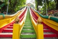 Kanchanaburi, Thailand-October 23, 2022 : Tourists are walking up and down the brightly colored stairs at Wat Tham Seua