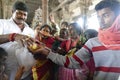 Indian man gives laddu treats to pilgrims