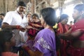 Indian man gives laddu treats to pilgrims