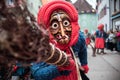 Funny witch with a red headscarf, lifts up the broom Royalty Free Stock Photo