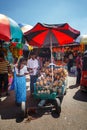 Sellers in street shop sell fresh fruits bananas, papaya and vegetables. Traditional Asian local market Royalty Free Stock Photo