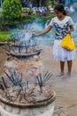 KANDY, SRI LANKA - JULY 19, 2016: White clothed Buddhist devotee lights incense sticks at the Temple of Sacred Tooth Royalty Free Stock Photo