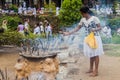 KANDY, SRI LANKA - JULY 19, 2016: White clothed Buddhist devotee lights incense sticks at the Temple of Sacred Tooth Royalty Free Stock Photo