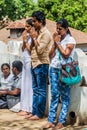 KANDY, SRI LANKA - JULY 19, 2016: White clothed buddhist pilgrims pray at Wel Bodiya with Bodhi tree during Poya Full