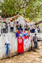 KANDY, SRI LANKA - JULY 19, 2016: White clothed buddhist pilgrims visit Wel Bodiya with Bodhi tree during Poya Full Moon