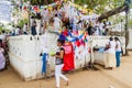 KANDY, SRI LANKA - JULY 19, 2016: White clothed buddhist pilgrims visit Wel Bodiya with Bodhi tree during Poya Full Moon