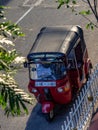 KANDY, SRI LANKA - March 12, 2019: Red tuktuk in the street of Kandy