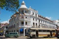 Traffic at the street in front of the historical building of the Queen`s hotel in Kandy, Sri Lanka. Royalty Free Stock Photo