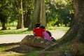 Couple relax at the palm trees alley in the Peradeniya Royal Botanical Garden in Kandy, Sri Lanka