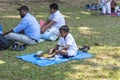 Kandy, Sri Lanka: 03/19/2019: Peradeniya Botanical Gardens small school boy seated eating traditional lunch of rice