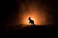 Kangaroo miniature standing at foggy night. Creative table decoration with colorful backlight with fog