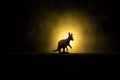 Kangaroo miniature standing at foggy night. Creative table decoration with colorful backlight with fog