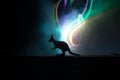 Kangaroo miniature standing at foggy night. Creative table decoration with colorful backlight with fog