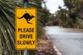 Kangaroo road sign. Please drive slowly yellow warning sign. Beware of kangaroos Royalty Free Stock Photo