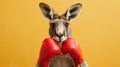 A kangaroo is wearing boxing gloves and standing in front of a yellow background