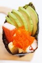 Kani with Avocado, Tamago Yaki Japanese Fried Egg and Ebiko Prawn Egg Tempura California or Temaki Sushi Hand Roll. Royalty Free Stock Photo