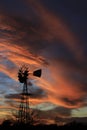 Kansas Awesome Sunset with colorful clouds, and a farm Windmill silhouette . Royalty Free Stock Photo