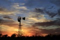 Kansas Awesome Sunset with colorful clouds, and a farm Windmill silhouette . Royalty Free Stock Photo