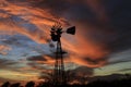 Kansas Awesome Sunset with colorful clouds, and a farm Windmill silhouette .