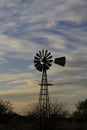 Kansas Awesome Sunset with colorful clouds, and a farm Windmill silhouette . Royalty Free Stock Photo