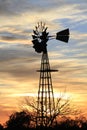 Kansas Awesome Sunset with colorful clouds, and a farm Windmill silhouette . Royalty Free Stock Photo